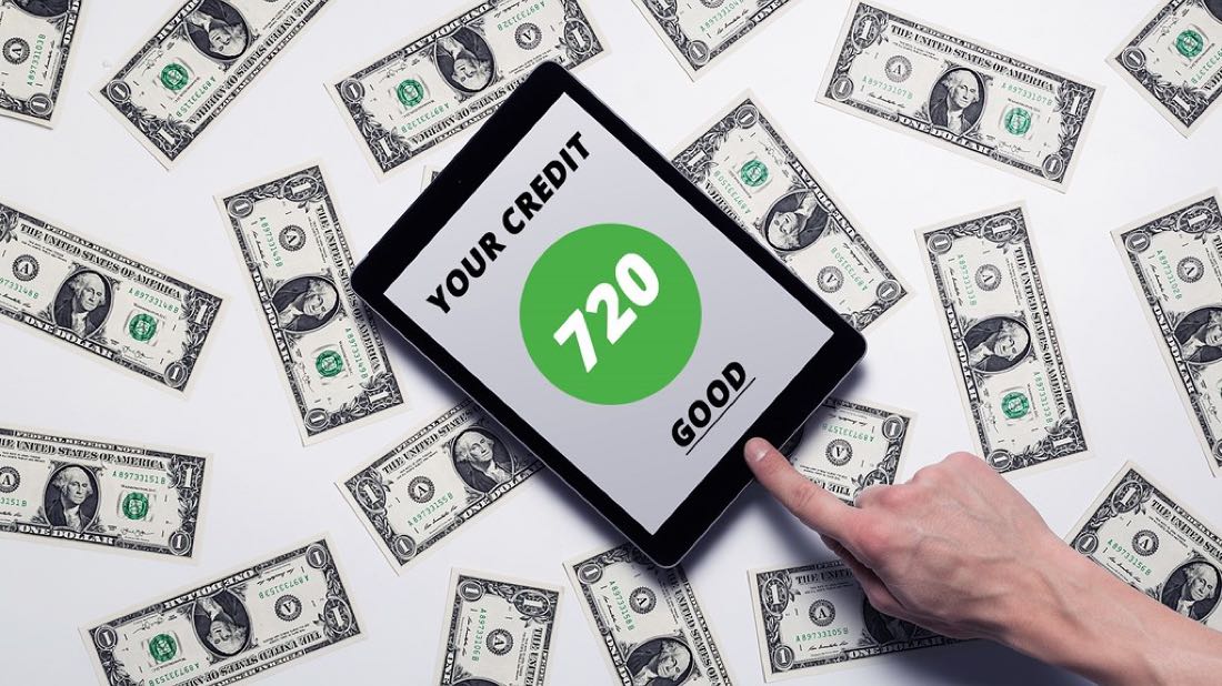 A printed credit score gauge showing a number in the good range